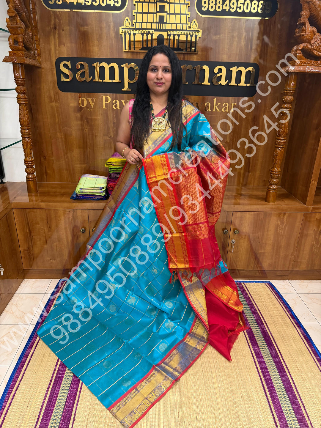 Ramar Blue with Red  , Rich Mayil and Chakram butta in the body with Zari Checks , Traditional borders and Rich Pallu Pure Silk Cotton Saree