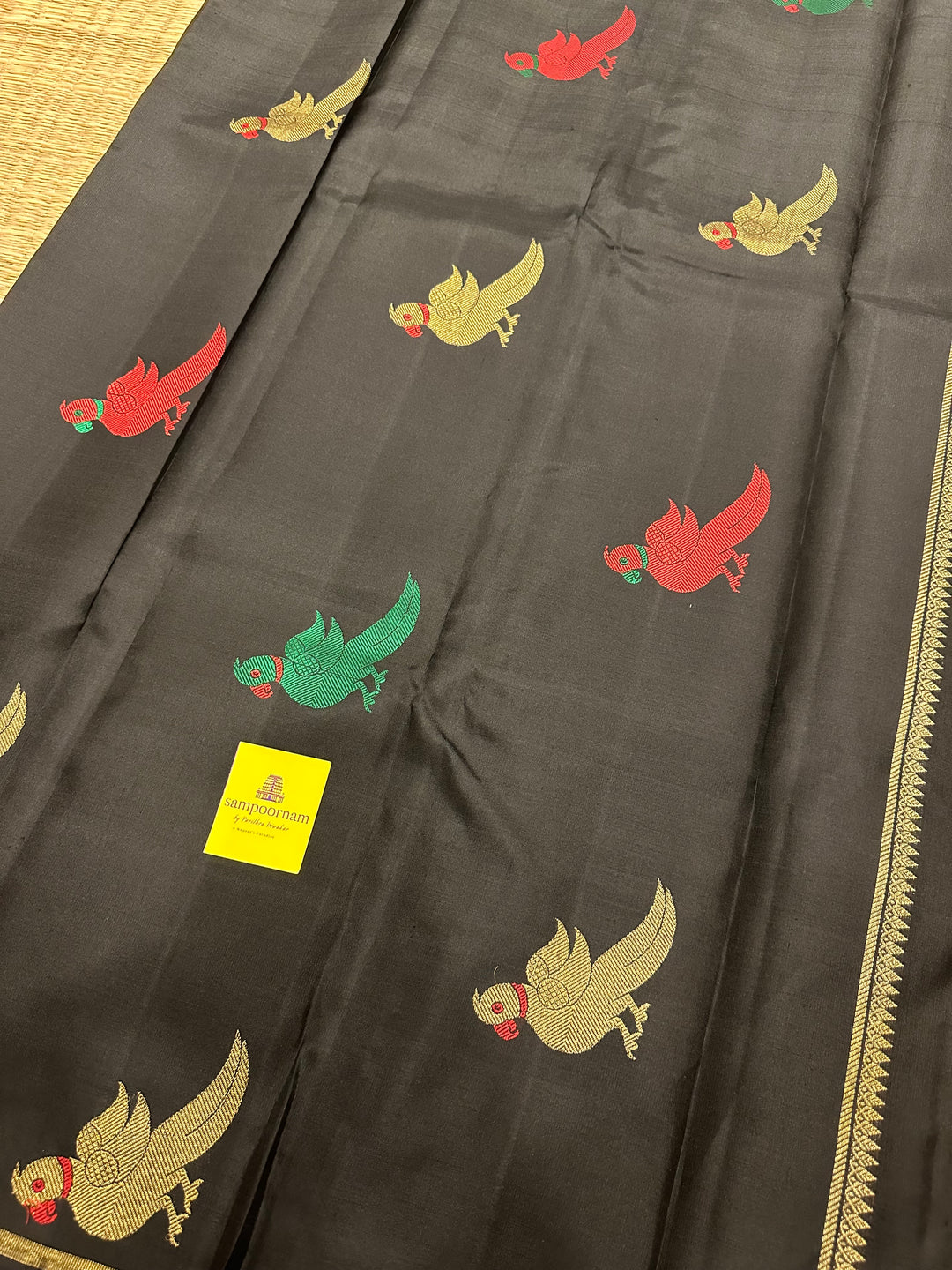 A Classic Black Saree with Kalakshetra Kili Butta in the body and Palla , with green and red thread work and gold Zari work, Rich Pallu Pure Kanjivaram Silk Saree