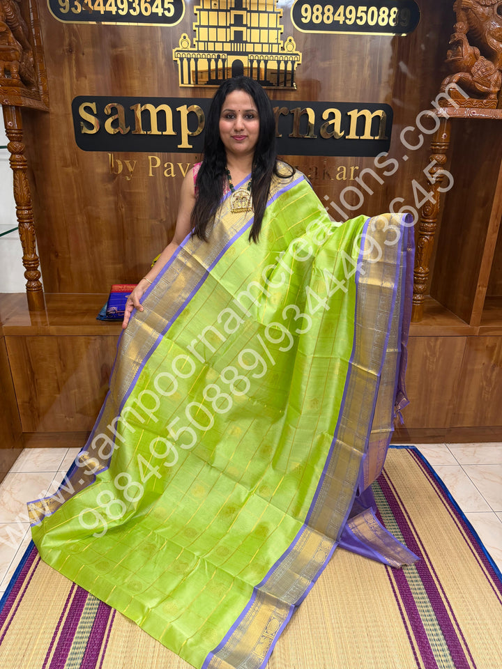 Pastel Green with Lavender  , Rich Mayil and Chakram butta in the body with Zari Checks , Traditional borders and Rich Pallu Pure Silk Cotton Saree