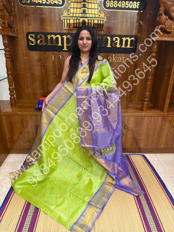 Pastel Green with Lavender  , Rich Mayil and Chakram butta in the body with Zari Checks , Traditional borders and Rich Pallu Pure Silk Cotton Saree