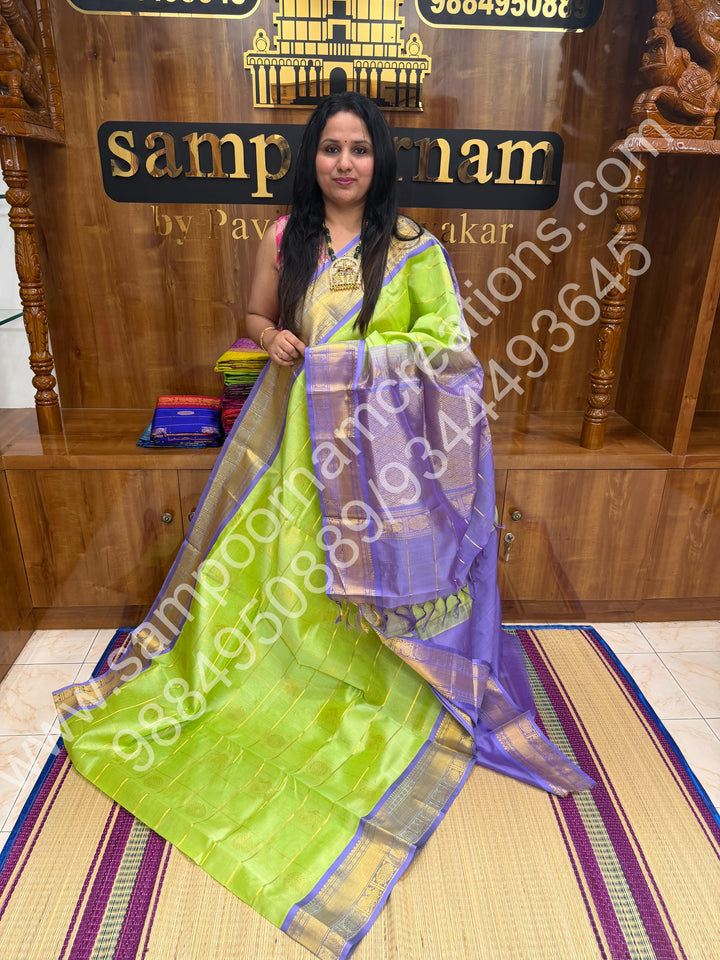 Pastel Green with Lavender  , Rich Mayil and Chakram butta in the body with Zari Checks , Traditional borders and Rich Pallu Pure Silk Cotton Saree