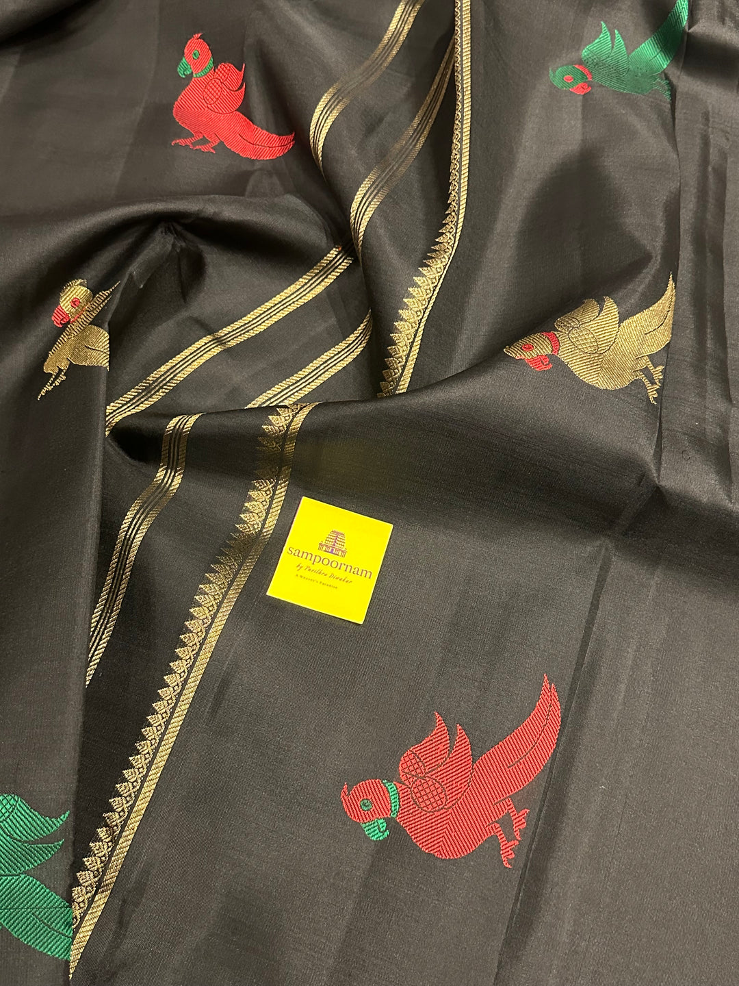 A Classic Black Saree with Kalakshetra Kili Butta in the body and Palla , with green and red thread work and gold Zari work, Rich Pallu Pure Kanjivaram Silk Saree