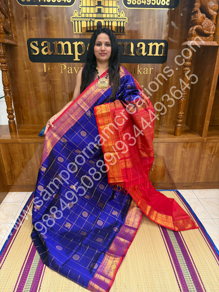 Indigo Blue with Red  , Rich Mayil and Chakram butta in the body with Zari Checks , Traditional borders and Rich Pallu Pure Silk Cotton Saree