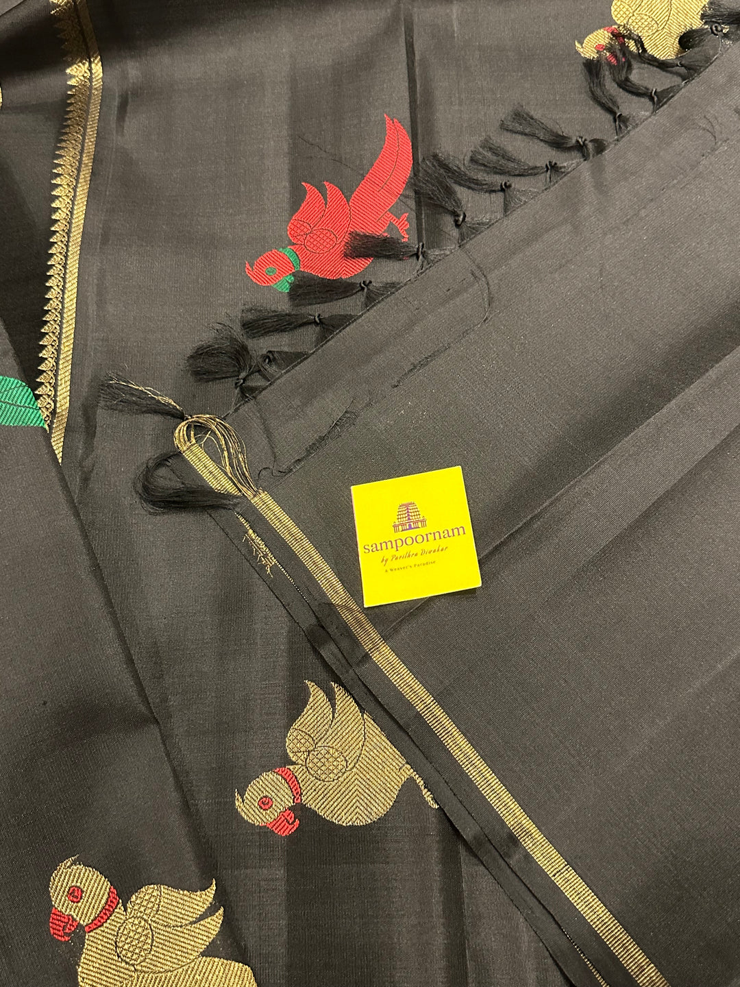 A Classic Black Saree with Kalakshetra Kili Butta in the body and Palla , with green and red thread work and gold Zari work, Rich Pallu Pure Kanjivaram Silk Saree