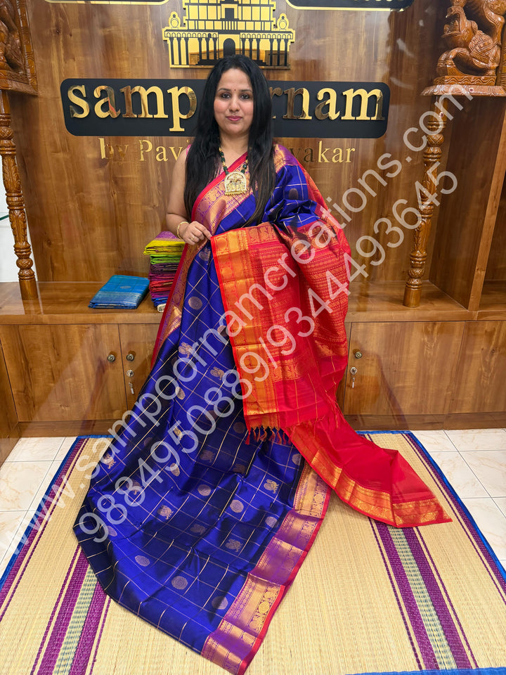 Indigo Blue with Red  , Rich Mayil and Chakram butta in the body with Zari Checks , Traditional borders and Rich Pallu Pure Silk Cotton Saree
