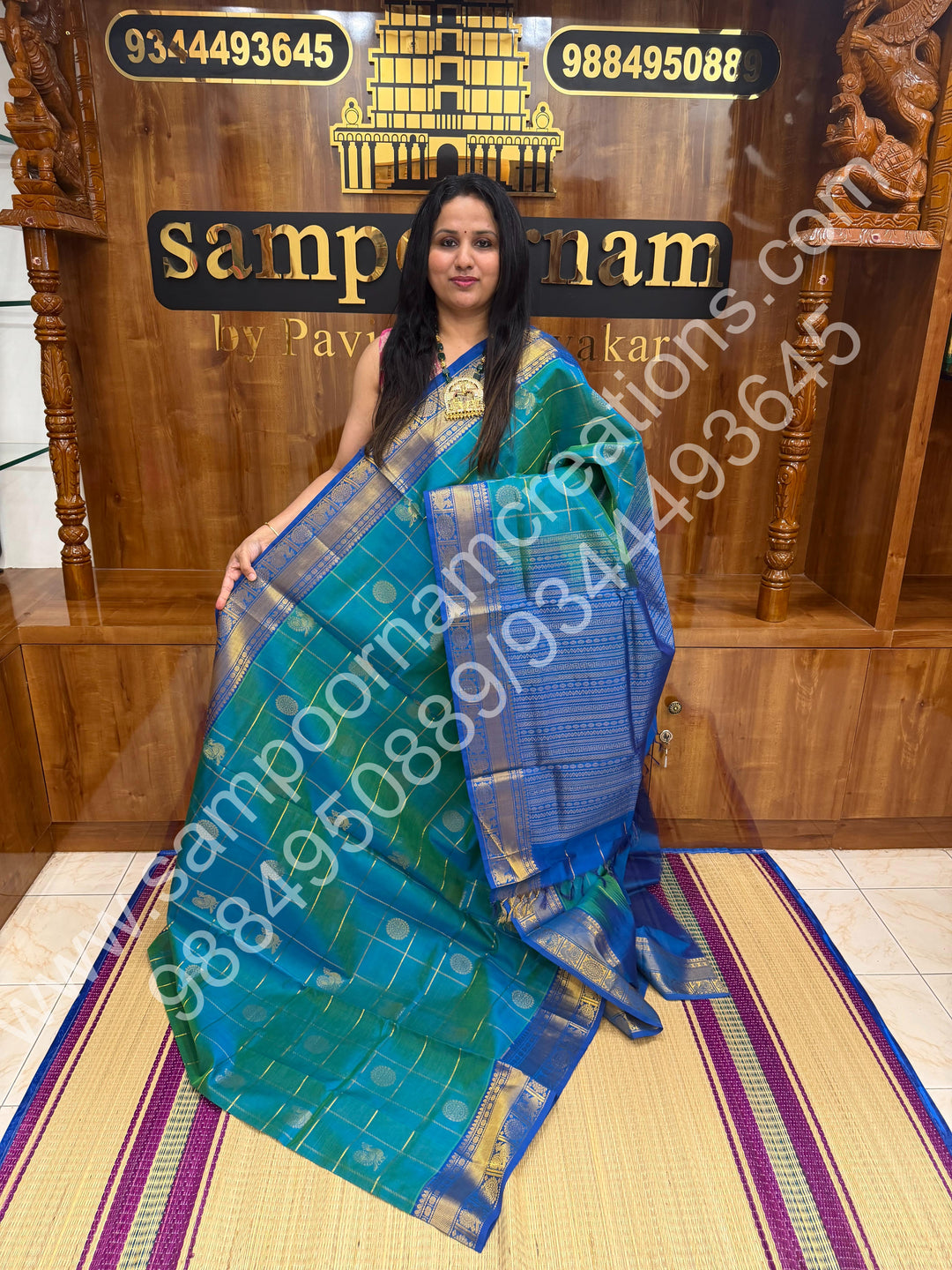 Double Shaded Teel Blue with Blue  , Rich Mayil and Chakram butta in the body with Zari Checks , Traditional borders and Rich Pallu Pure Silk Cotton Saree