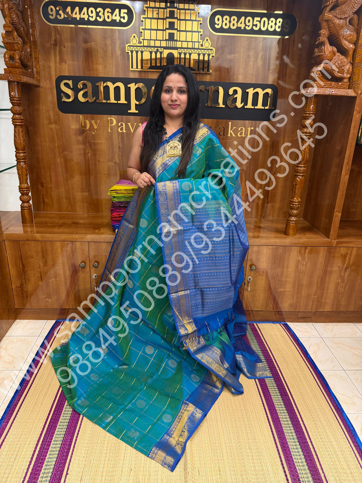 Double Shaded Teel Blue with Blue  , Rich Mayil and Chakram butta in the body with Zari Checks , Traditional borders and Rich Pallu Pure Silk Cotton Saree
