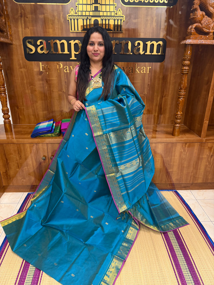 Double Shaded Chinthamani Blue , Pink Selvedge Vairaoosi Zari lines with Rich Annam and Rudraksh  Zari Butta in the body , traditional borders and Rich Pallu Pure Silk Cotton Saree