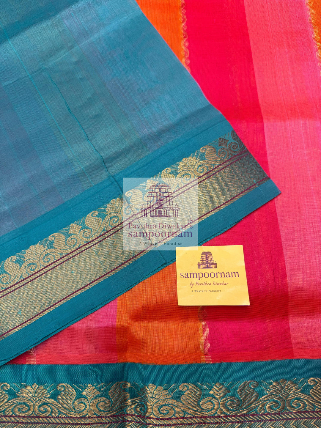 A fusion of colours, pink, orange, peach and turquoise blue, with traditional borders and rich pallu Korvai Silk Cotton Saree