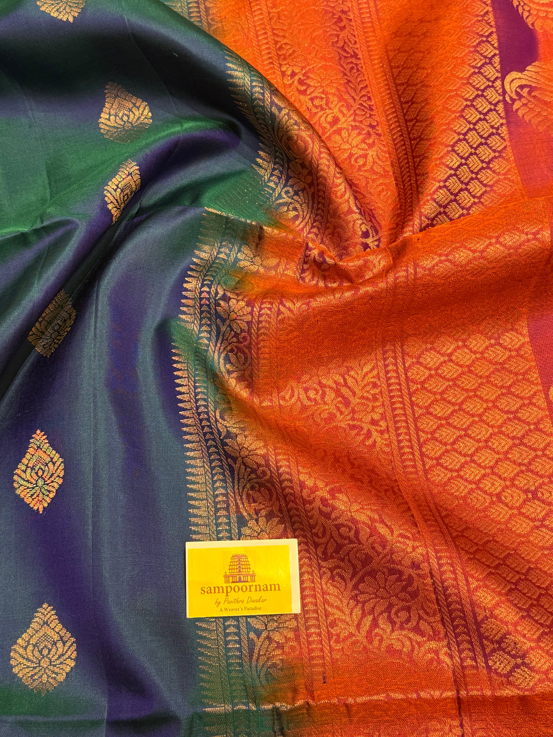 Traditional Mayilkazhuthu Blue with Orangish Pink , Rich Zari Motifs in the Body and Traditional Rich Pallu Pure Soft Silk Saree