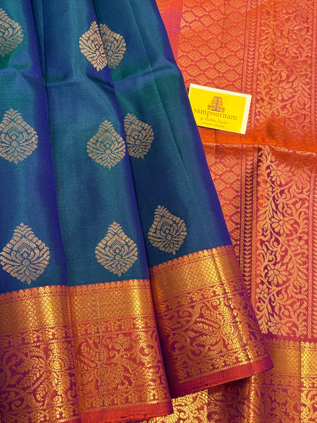 Traditional Mayilkazhuthu Blue with Orangish Pink , Rich Zari Motifs in the Body and Traditional Rich Pallu Pure Soft Silk Saree