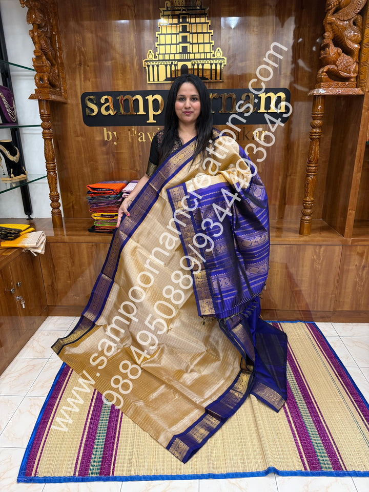 Beige with Dark Blue  , rich Zari checks in the body , traditional borders and rich Pallu Korvai Silk Cotton