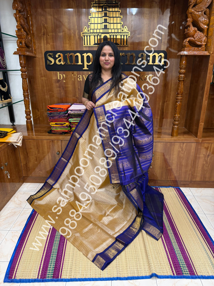 Beige with Dark Blue  , rich Zari checks in the body , traditional borders and rich Pallu Korvai Silk Cotton
