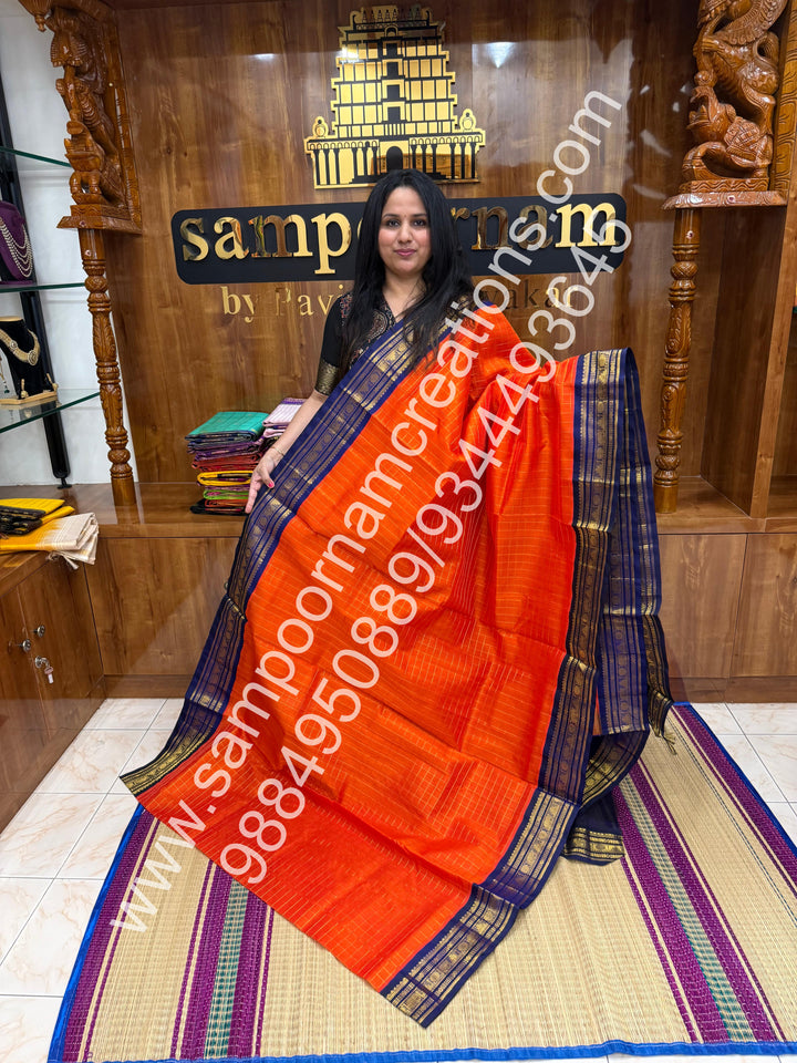 Rust Orange with Dark Blue  , rich Zari checks in the body , traditional borders and rich Pallu Korvai Silk Cotton