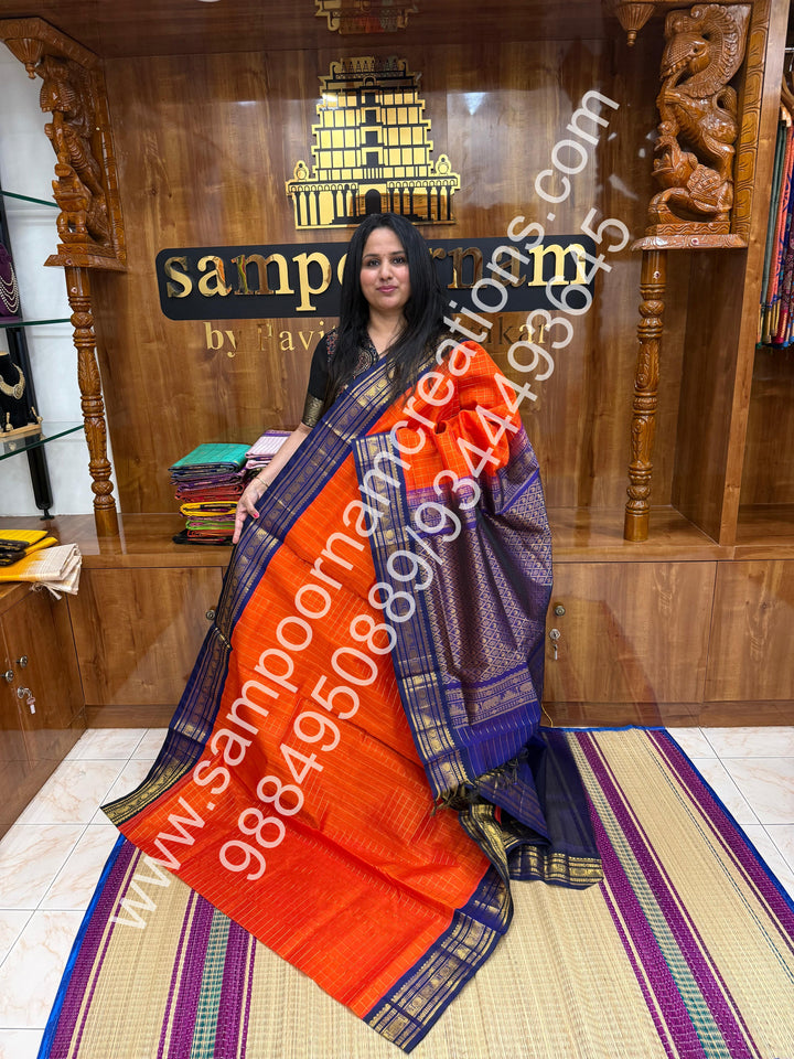 Rust Orange with Dark Blue  , rich Zari checks in the body , traditional borders and rich Pallu Korvai Silk Cotton