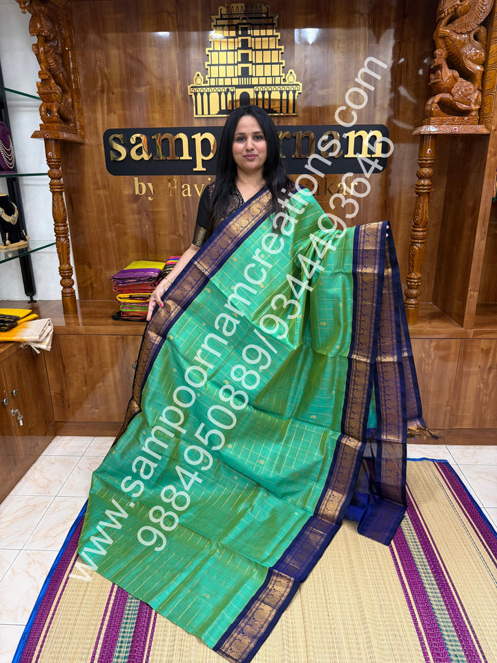 Double Shaded Ramar Blue , rich Zari checks with Mango  butta in the body , traditional  borders  and rich Pallu Korvai Silk Cotton Saree