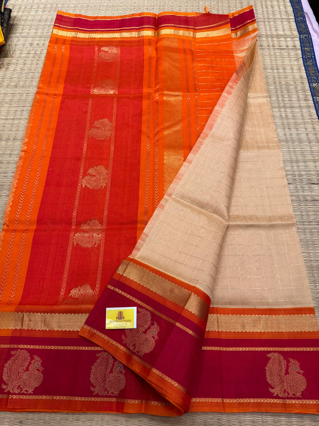 Biscuit Colour with Orange and Red,with Annam Motifs in the Border and Zari checks in the Body and Rich Pallu Korvai Silk Cotton Saree
