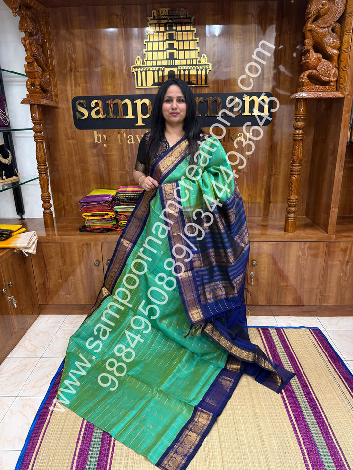 Double Shaded Ramar Blue , rich Zari checks with Mango  butta in the body , traditional  borders  and rich Pallu Korvai Silk Cotton Saree