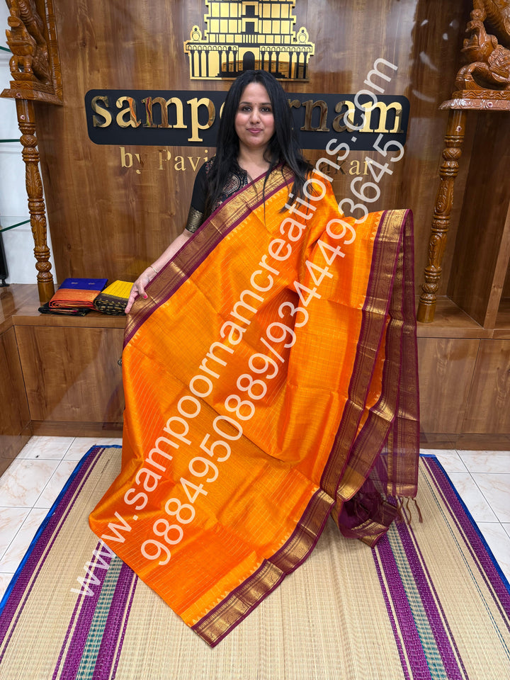 Kanakambaram with Maroon  , rich Zari checks in the body , traditional borders with temple design  and rich Pallu Korvai Silk Cotton