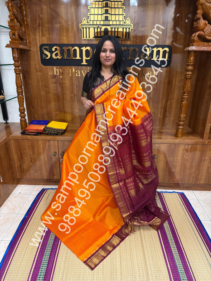 Kanakambaram with Maroon  , rich Zari checks in the body , traditional borders with temple design  and rich Pallu Korvai Silk Cotton