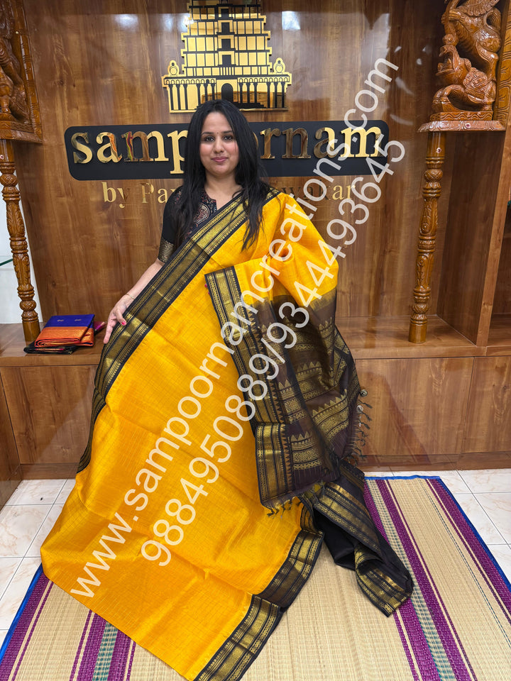Manjal with Dark Brown  , rich Zari checks in the body , traditional borders and rich Pallu Korvai Silk Cotton