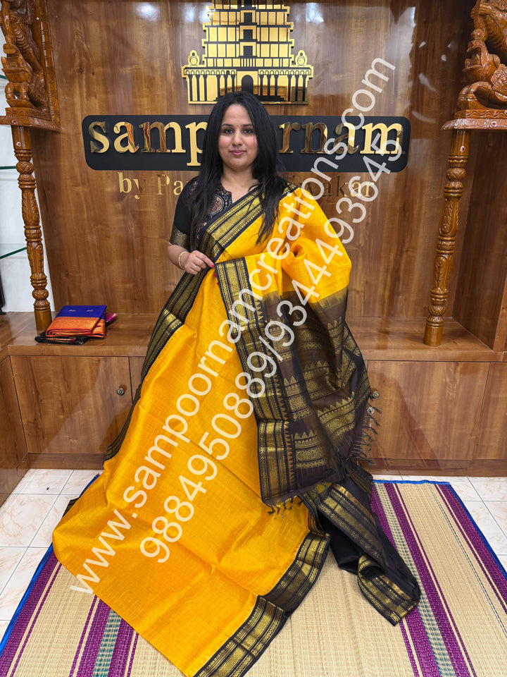 Manjal with Dark Brown  , rich Zari checks in the body , traditional borders and rich Pallu Korvai Silk Cotton