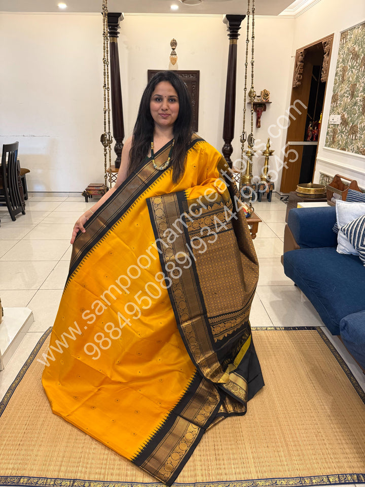 A classic Mambazha Manjal with Black, Rich Gold Zari Butta in the Body, Traditional Rich Borders and Grand Pallu, Pure Handloom Gadwal Silk Saree