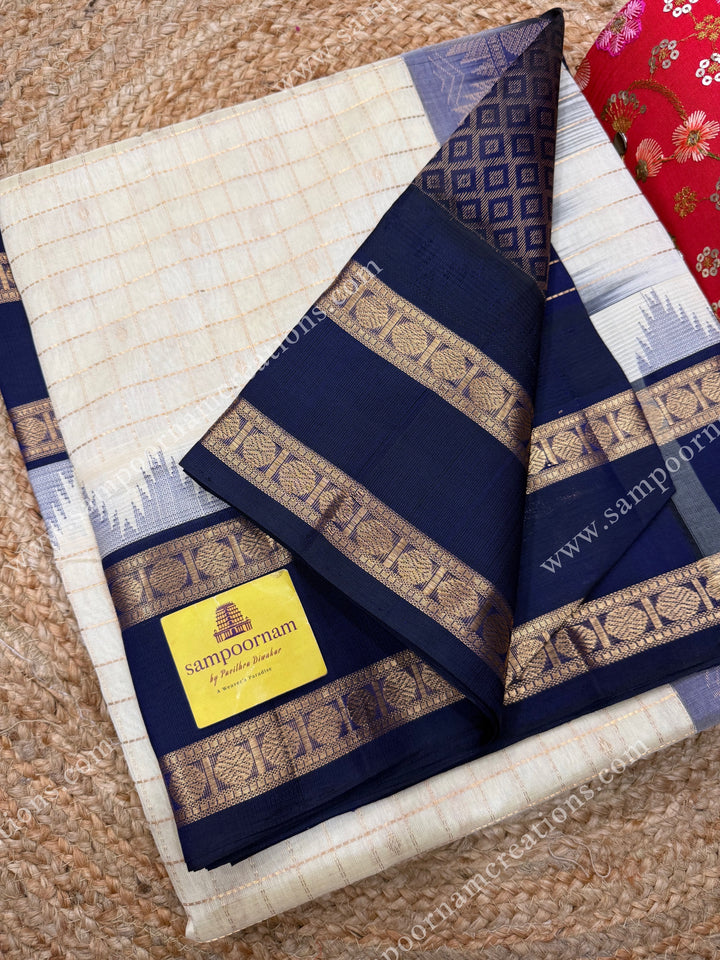 Offwhite with Dark Blue  , Rich Zari checks and Butta in the body and  rettapet  borders , rich Pallu Korvai Silk Cotton Sareee