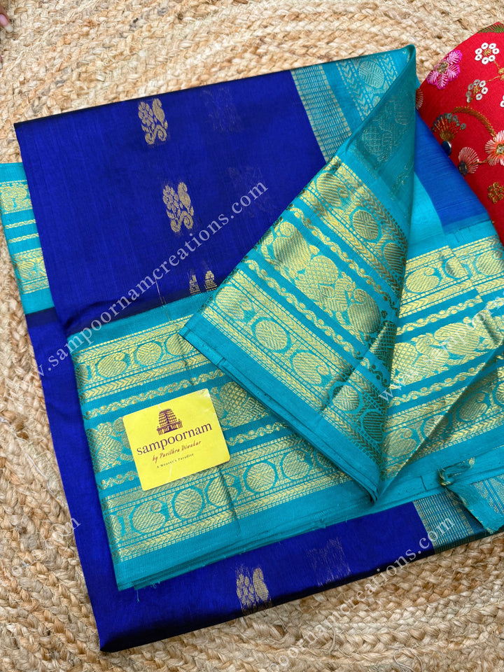 Indigo Blue with Light Blue  , Rich Zari butta in the body and Traditional Kanchi borders and  rich Pallu Korvai Silk Cotton Sareee