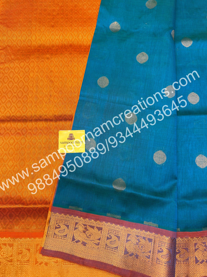 Blue with Mambazha Manjal , rich Coin Zari butta in the body , traditional  borders and rich Pallu silk cotton saree