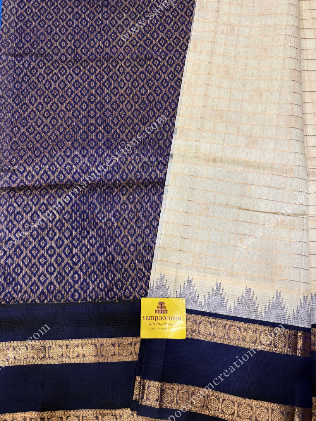 Offwhite with Dark Blue  , Rich Zari checks and Butta in the body and  rettapet  borders , rich Pallu Korvai Silk Cotton Sareee