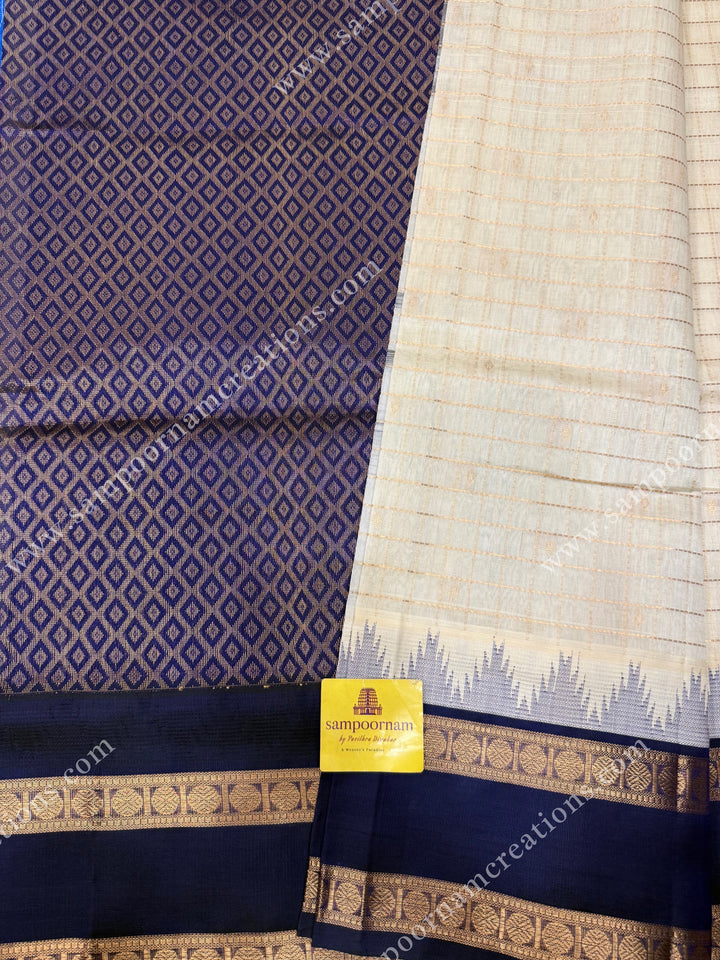 Offwhite with Dark Blue  , Rich Zari checks and Butta in the body and  rettapet  borders , rich Pallu Korvai Silk Cotton Sareee