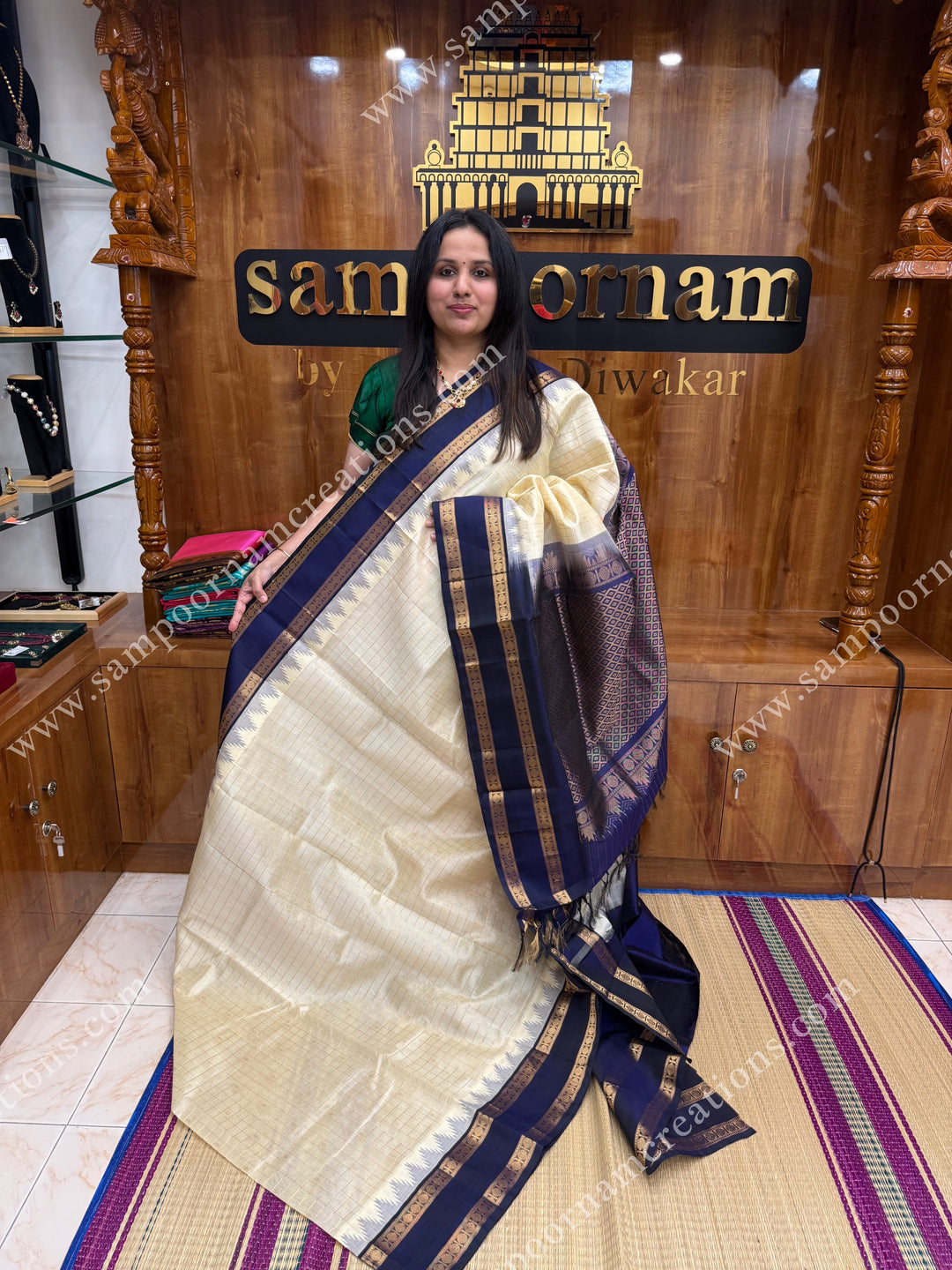 Offwhite with Dark Blue  , Rich Zari checks and Butta in the body and  rettapet  borders , rich Pallu Korvai Silk Cotton Sareee