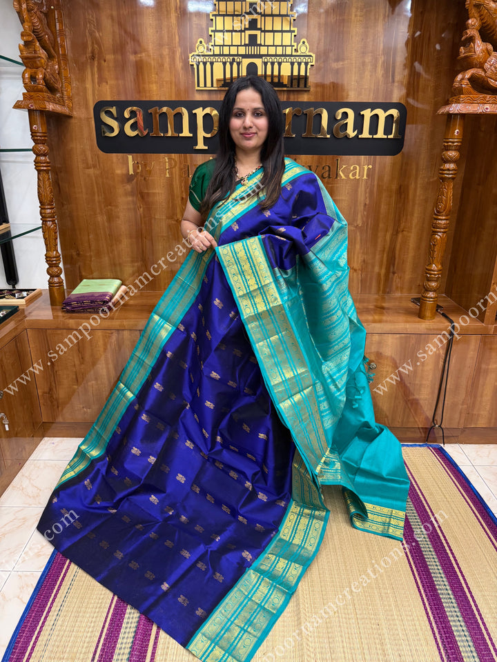 Indigo Blue with Light Blue  , Rich Zari butta in the body and Traditional Kanchi borders and  rich Pallu Korvai Silk Cotton Sareee