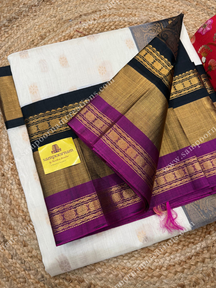 Offwhite with Black , Rich Floral Zari butta in the body and Oneside Triple  borders , rich Pallu Korvai Silk Cotton Sareee