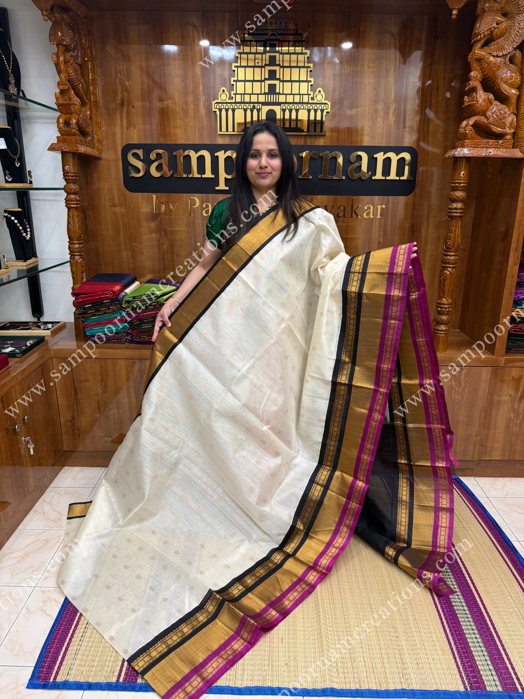 Offwhite with Black , Rich Floral Zari butta in the body and Oneside Triple  borders , rich Pallu Korvai Silk Cotton Sareee
