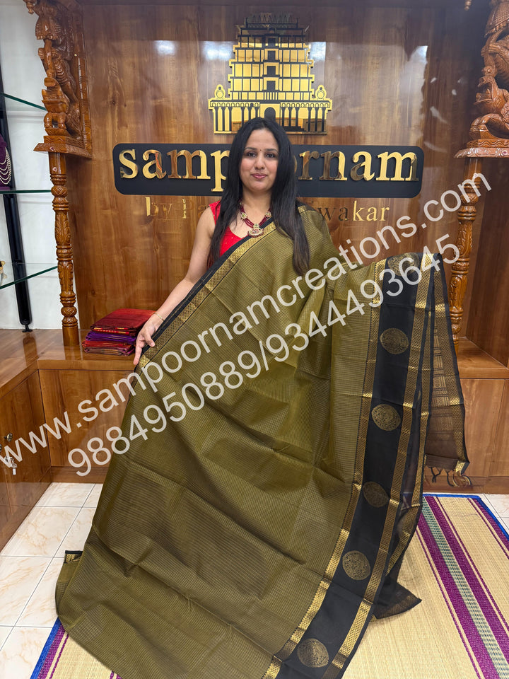 Masani green with Black  rich Zari checks in the body and Peacock motif in the  border ,rettapet borders  rich Pallu Silk Cotton Saree