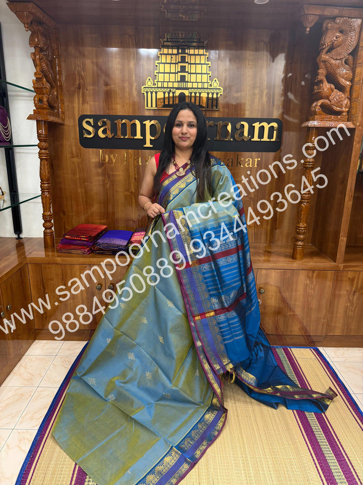 Double Shaded Ramar Green with Blue , rich Kolam Zari butta in the body , rettapet borders  and Grand Pallu Silk Cotton Saree