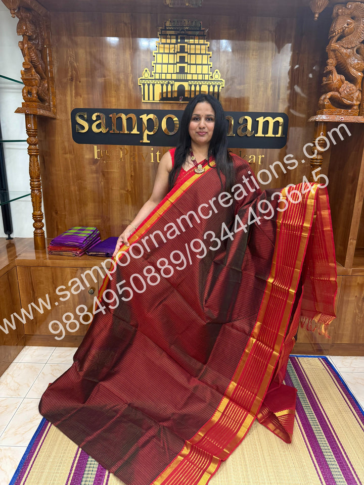 Maroon with Red , rich Zari checks in the body and traditional Veldhari  border , rich Pallu Silk Cotton Saree