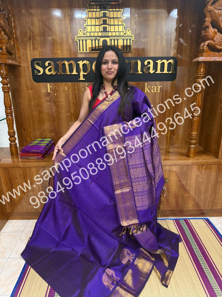 Violet Elegant Elephant zari buttu in the borders , zari checks in the body and rich Pallu Silk Cotton Saree