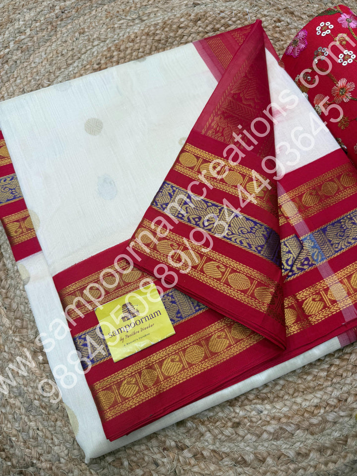 Cream with Red , rich Mango and Rudraksh Zari butta in the body , traditional Kanchi Borders , rich traditional borders and Grand Pallu Korvai Silk Cotton Saree