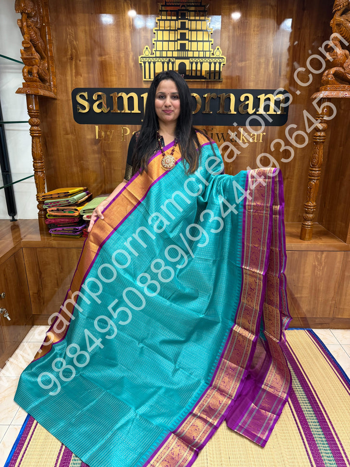 Ocean Blue with Purple , rich traditional borders and Lakshadeepam Zari Buttas all over the body and Grand Pallu Korvai Silk Cotton Saree