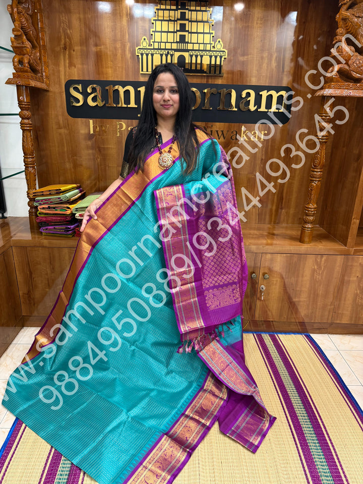 Ocean Blue with Purple , rich traditional borders and Lakshadeepam Zari Buttas all over the body and Grand Pallu Korvai Silk Cotton Saree