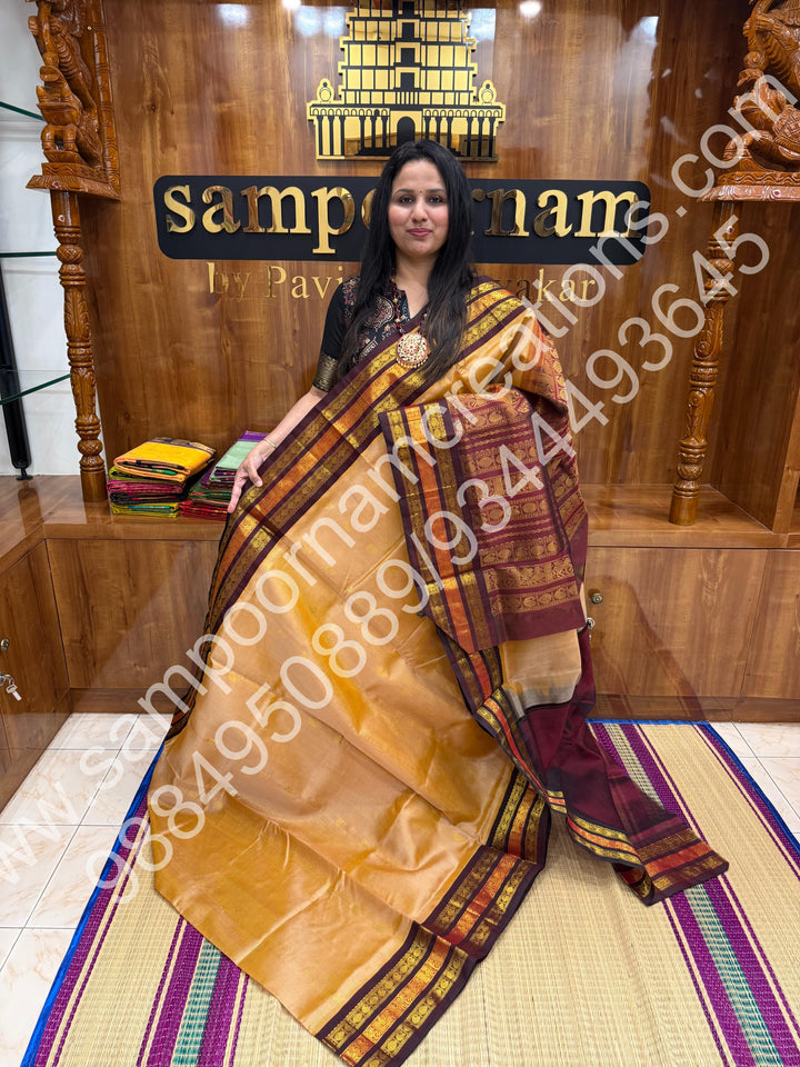 Biscuit with Brown  , rich Zari Podi Kattam with Mango butta in the body , traditional Kanchi border and rich Pallu Korvai Silk Cotton Saree