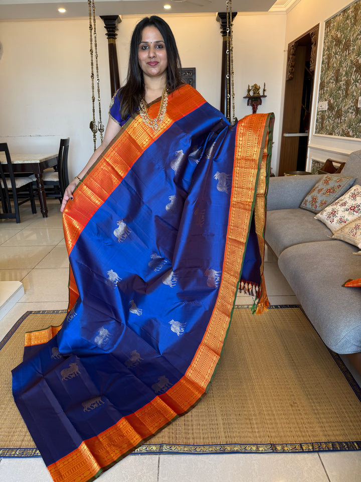 Cobalt Blue with Fanta orange, Gomatha and Kannukutty Zari Rich Butta all over the body , traditional Kanchi border and rich Pallu Korvai Pure Kanjivaram Silk saree