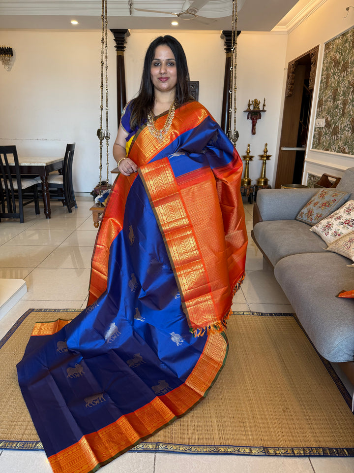 Cobalt Blue with Fanta orange, Gomatha and Kannukutty Zari Rich Butta all over the body , traditional Kanchi border and rich Pallu Korvai Pure Kanjivaram Silk saree