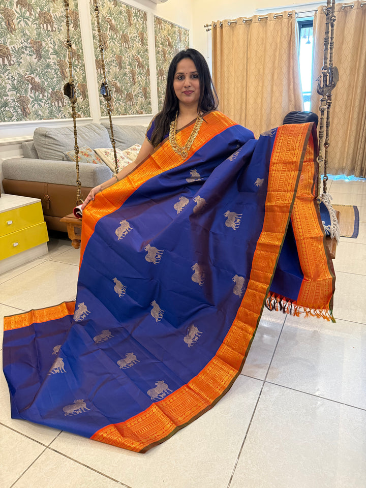 Cobalt Blue with Fanta orange, Gomatha and Kannukutty Zari Rich Butta all over the body , traditional Kanchi border and rich Pallu Korvai Pure Kanjivaram Silk saree