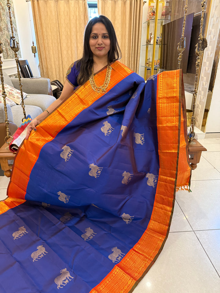 Cobalt Blue with Fanta orange, Gomatha and Kannukutty Zari Rich Butta all over the body , traditional Kanchi border and rich Pallu Korvai Pure Kanjivaram Silk saree