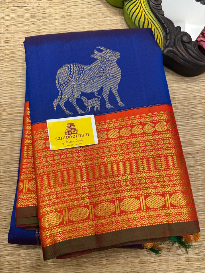 Cobalt Blue with Fanta orange, Gomatha and Kannukutty Zari Rich Butta all over the body , traditional Kanchi border and rich Pallu Korvai Pure Kanjivaram Silk saree
