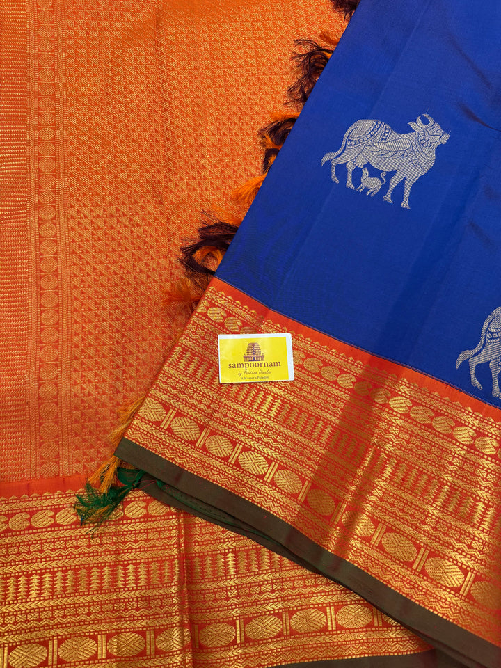 Cobalt Blue with Fanta orange, Gomatha and Kannukutty Zari Rich Butta all over the body , traditional Kanchi border and rich Pallu Korvai Pure Kanjivaram Silk saree